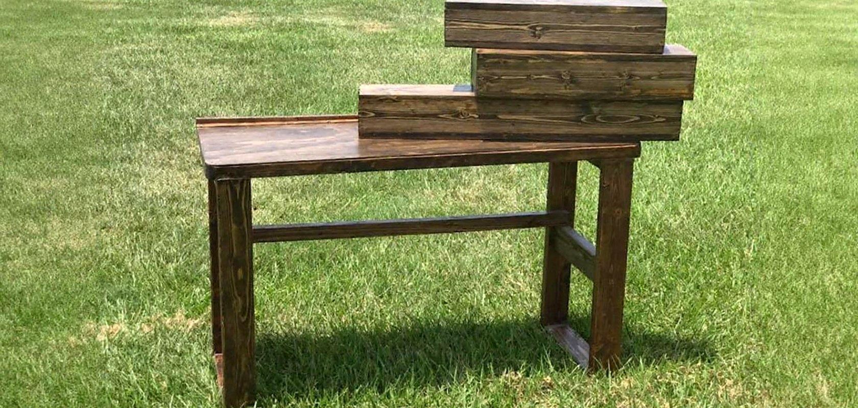 A dark stained console table with matching storage boxes, built in the shop