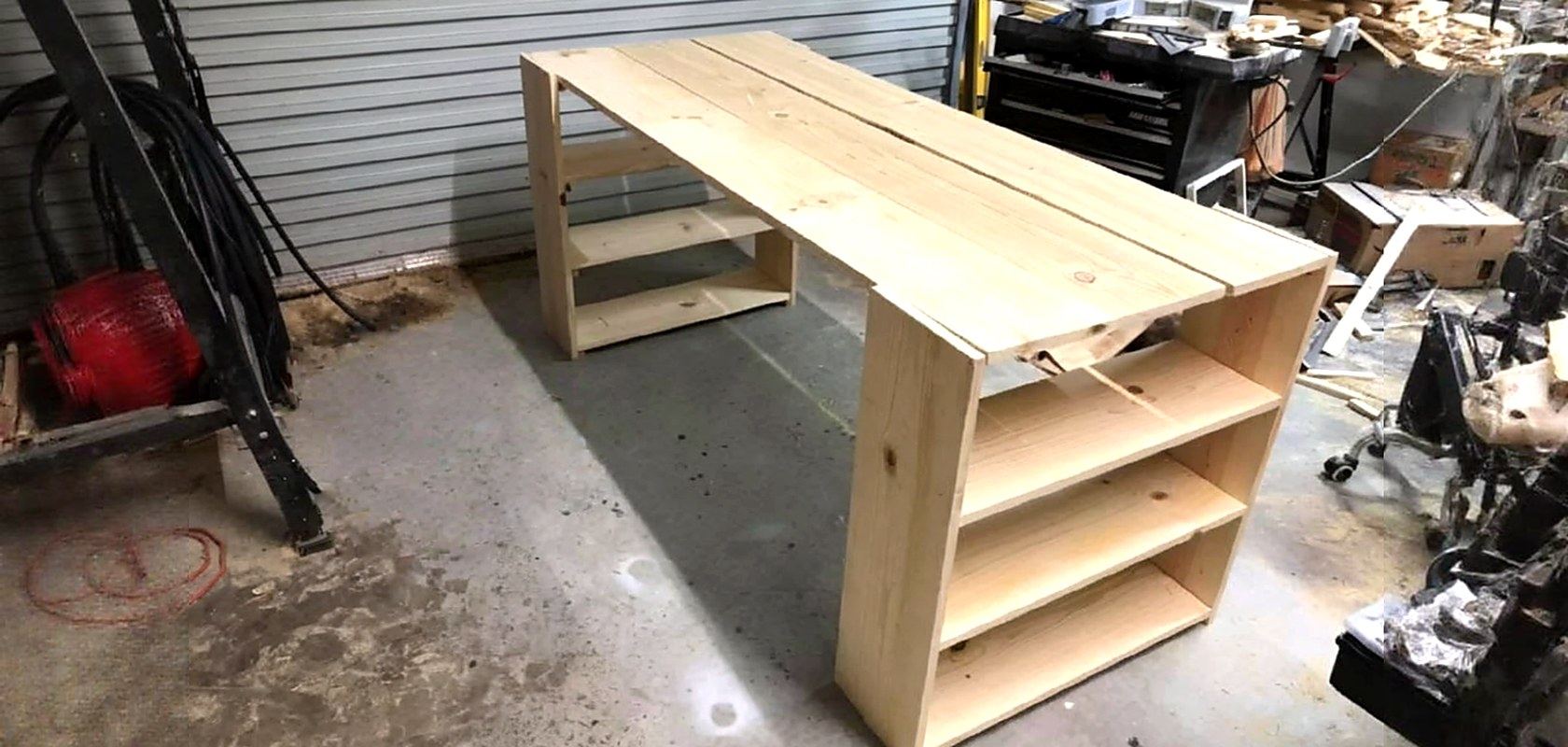 A pine desk with built-in shelving under construction in the shop